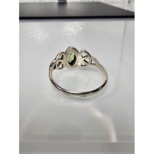 345 - A brand new pretty 925 Silver ring set with a marquise cut peridot gemstone having a trinity symbol ... 