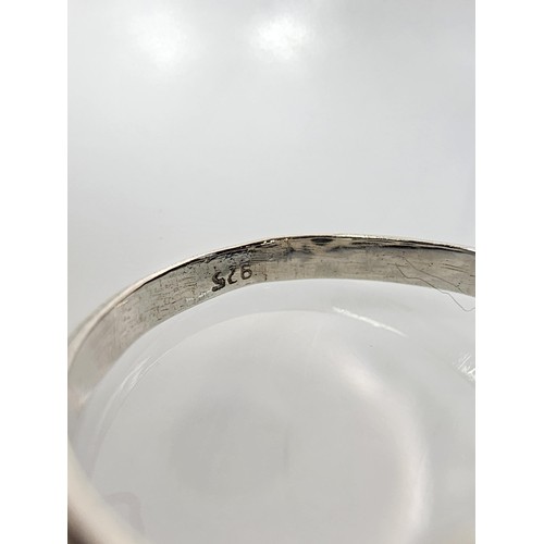 345 - A brand new pretty 925 Silver ring set with a marquise cut peridot gemstone having a trinity symbol ... 