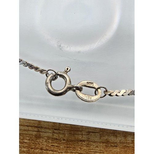 339 - 2x 925 Silver necklaces to include an interesting silver necklace with an middle eastern design feat... 