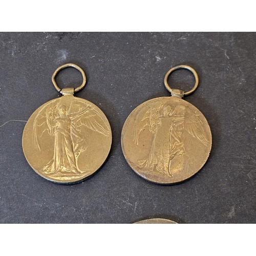 256 - A quantity of collectable badges to include 2x brass Institute Staff War Department identity tags da... 