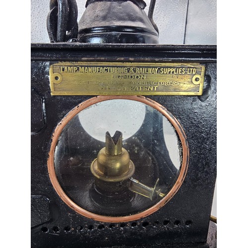 265 - An early 20th century British railway signal lamp of square section blackened metal construction wit... 
