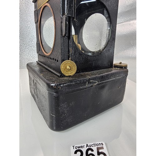 265 - An early 20th century British railway signal lamp of square section blackened metal construction wit... 