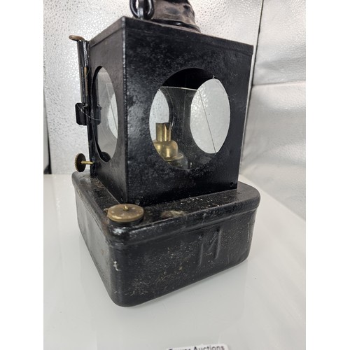 265 - An early 20th century British railway signal lamp of square section blackened metal construction wit... 