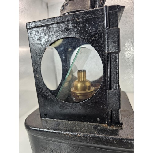 265 - An early 20th century British railway signal lamp of square section blackened metal construction wit... 