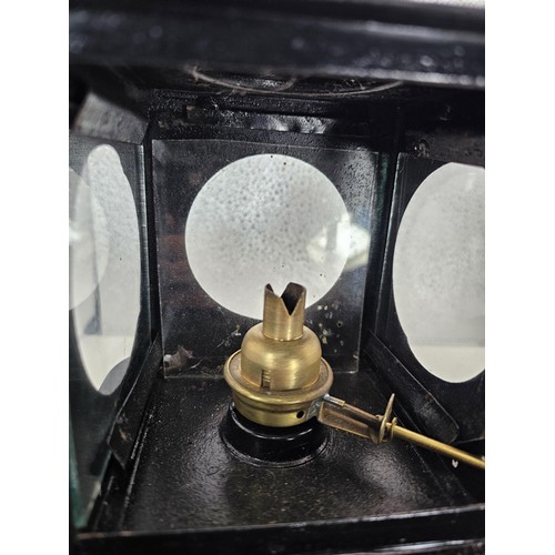 265 - An early 20th century British railway signal lamp of square section blackened metal construction wit... 