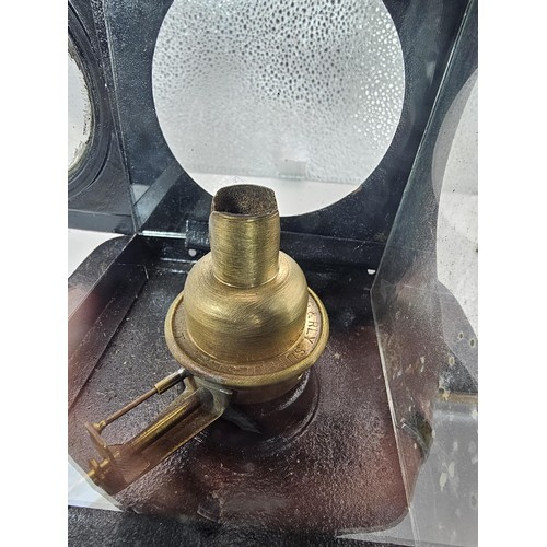 265 - An early 20th century British railway signal lamp of square section blackened metal construction wit... 