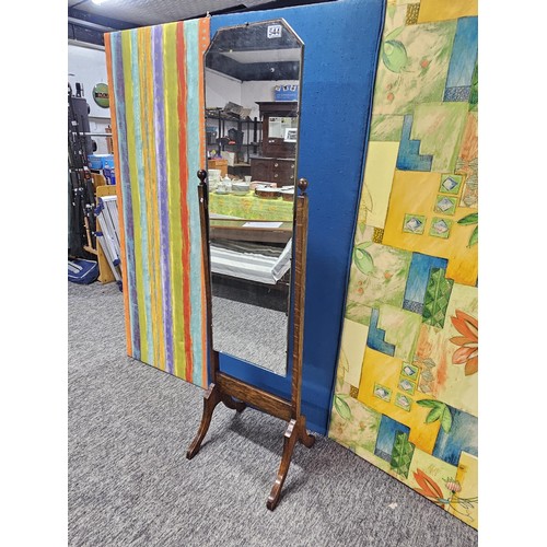 544 - A good quality vintage floor stand cheval mirror in an oak frame, with metal clips to hold the mirro... 