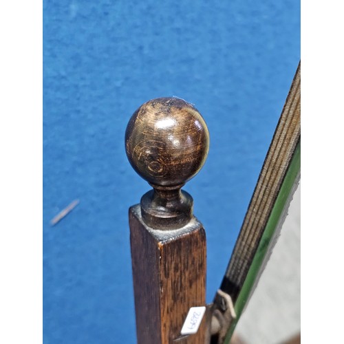 544 - A good quality vintage floor stand cheval mirror in an oak frame, with metal clips to hold the mirro... 