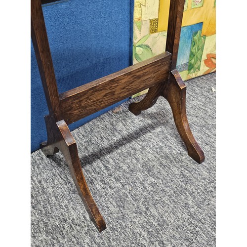 544 - A good quality vintage floor stand cheval mirror in an oak frame, with metal clips to hold the mirro... 