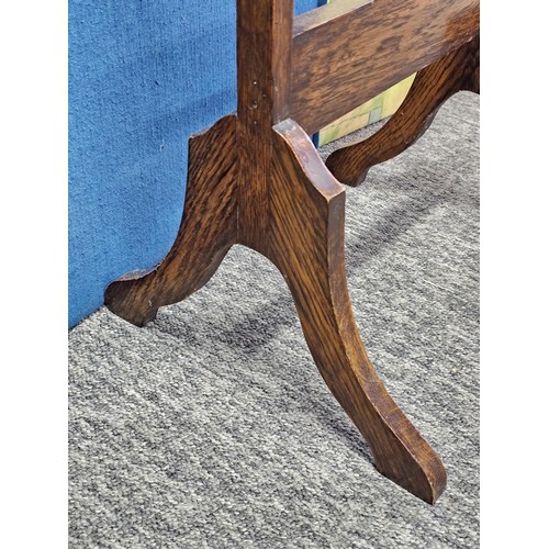 544 - A good quality vintage floor stand cheval mirror in an oak frame, with metal clips to hold the mirro... 