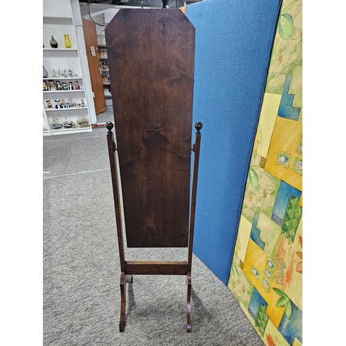 544 - A good quality vintage floor stand cheval mirror in an oak frame, with metal clips to hold the mirro... 