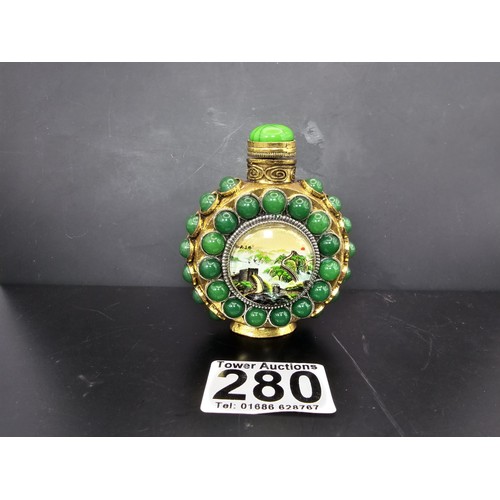 280 - An attractive ornate Asian scent bottle set with green stones having a green stone to the lid, the l... 