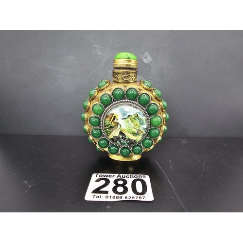 280 - An attractive ornate Asian scent bottle set with green stones having a green stone to the lid, the l... 