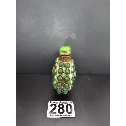 280 - An attractive ornate Asian scent bottle set with green stones having a green stone to the lid, the l... 