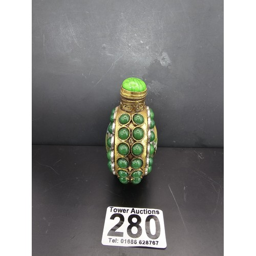 280 - An attractive ornate Asian scent bottle set with green stones having a green stone to the lid, the l... 