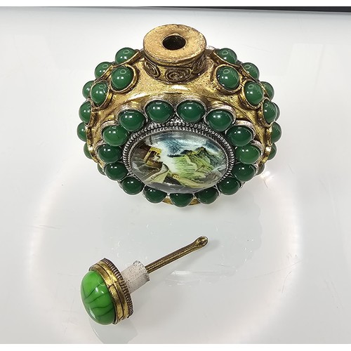 280 - An attractive ornate Asian scent bottle set with green stones having a green stone to the lid, the l... 