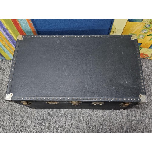 549 - A good quality black travelling trunk with brass clasps in good order, ideal for converting to a cof... 