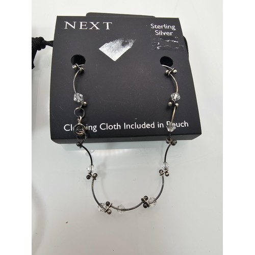 355 - A brand new Next sterling silver bangle with a wave shaped design along with a brand new Next sterli... 