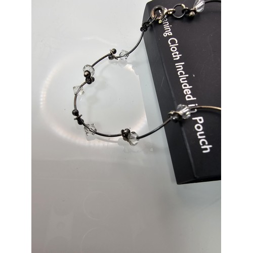 355 - A brand new Next sterling silver bangle with a wave shaped design along with a brand new Next sterli... 