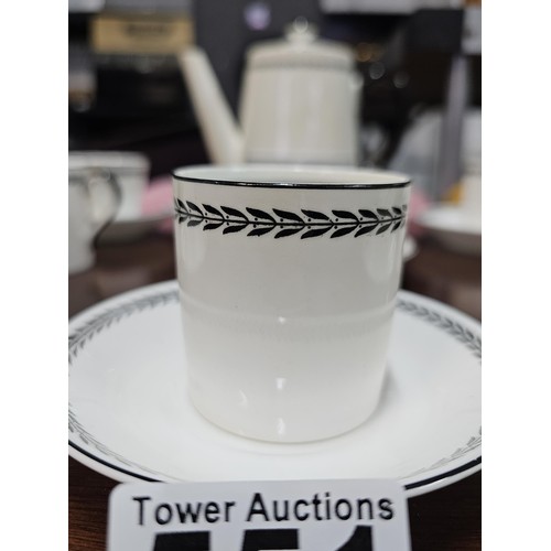 551 - A vintage Paragon 15 piece teaset in black and white with a garland design to the top, consisting of... 