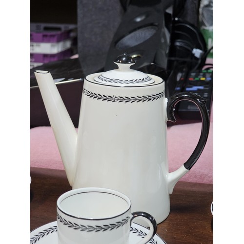 551 - A vintage Paragon 15 piece teaset in black and white with a garland design to the top, consisting of... 