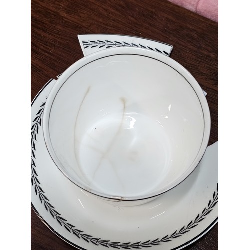 551 - A vintage Paragon 15 piece teaset in black and white with a garland design to the top, consisting of... 
