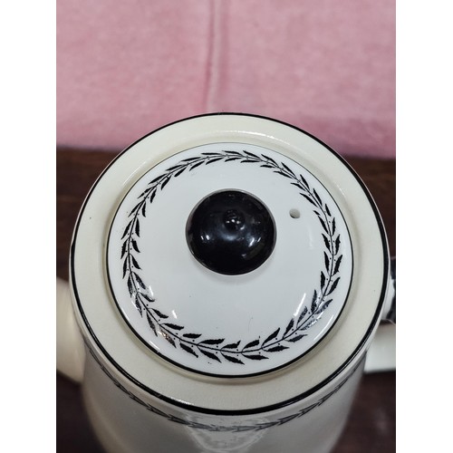 551 - A vintage Paragon 15 piece teaset in black and white with a garland design to the top, consisting of... 