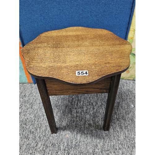 554 - A good quality vintage scalloped wooden sewing table with lift up lid in oak, the lid lifts to a fit... 