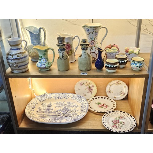 261 - A shelf full of collectable ceramics and earthenware to include 2 handmade salt sellers in the form ... 