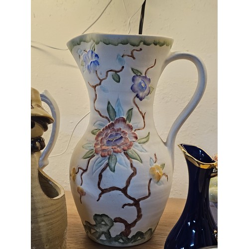 261 - A shelf full of collectable ceramics and earthenware to include 2 handmade salt sellers in the form ... 