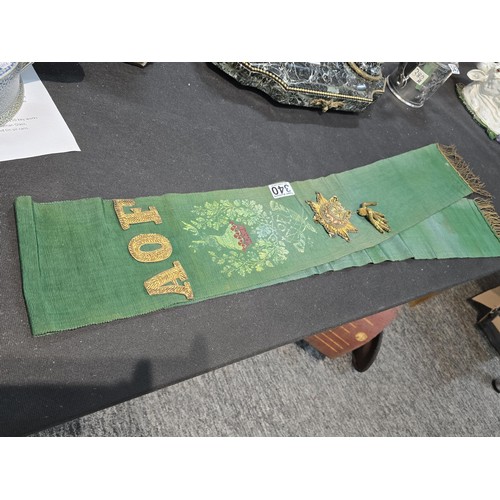 455 - A senior officers ceremonial sash of ribbed green moire silk prominently applied with genuine gold b... 