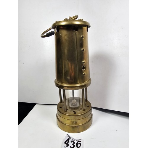 436 - A Welsh brass minors paraffin lamp of cylindrical form applied with a Cymru dragon badge and fully s... 