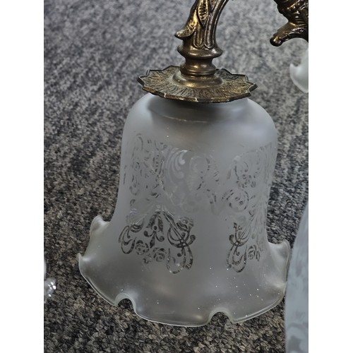 5 - A three tier ceiling chandelier with a brushed brass design with three fluted opaque glass shades an... 