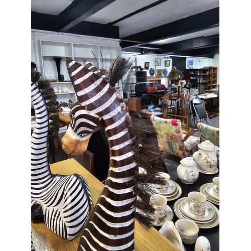 8 - A collection of three graduated wooden zebra's figures in a comical design. One of the zebra's has a... 