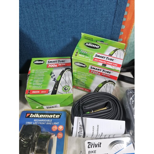 13 - A box containing a quantity of cycling accessories to include slime smart tubes, a rechargeable fron... 