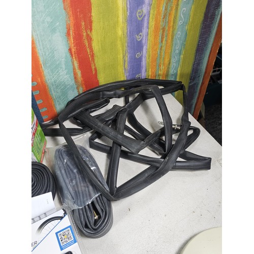 13 - A box containing a quantity of cycling accessories to include slime smart tubes, a rechargeable fron... 