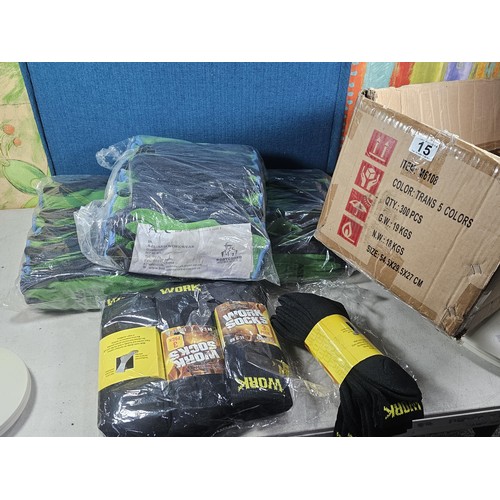 15 - A large quantity of new and sealed Asda work gloves along with twelve pairs of work socks.