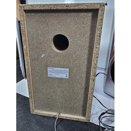29 - A pair Sony table top speakers with a wood veneer along with a pair of unbranded speakers