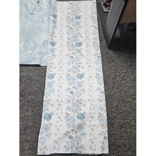 39 - A collection of 3x pairs of Laura Ashley curtains to include a blue dog pattern pair, a light blue p... 