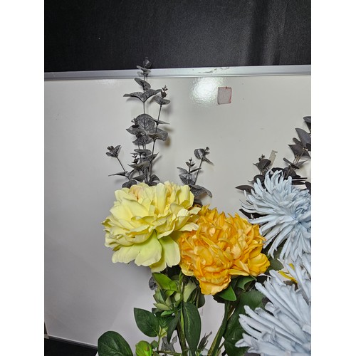 21 - A good quality glass vase with firing imperfections containing a quantity of artificial flowers. alo... 