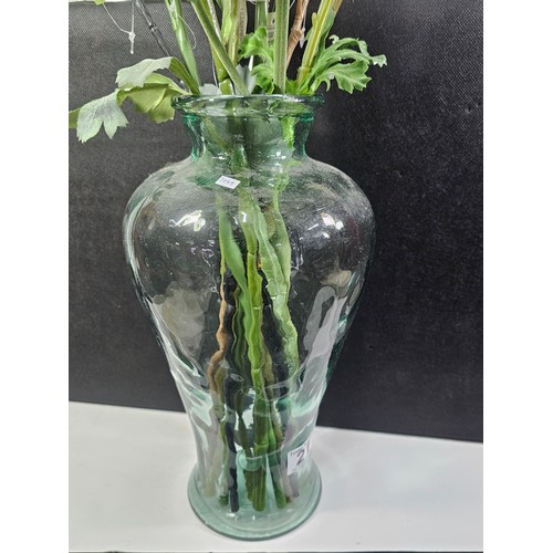 21 - A good quality glass vase with firing imperfections containing a quantity of artificial flowers. alo... 