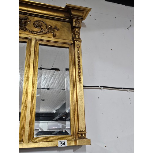 54 - A large ornate gilded triple over mantle bevel edged mirror with a Egyptian frieze to the top, a pha... 
