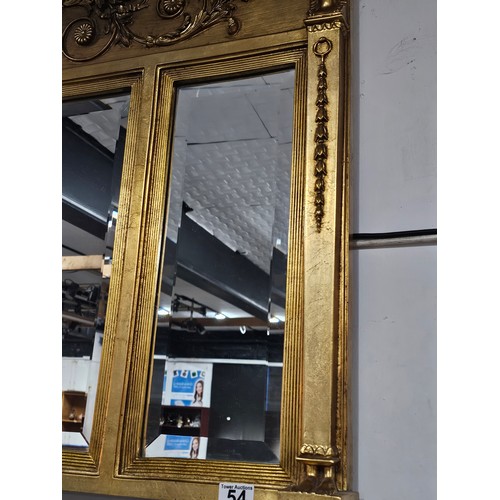 54 - A large ornate gilded triple over mantle bevel edged mirror with a Egyptian frieze to the top, a pha... 
