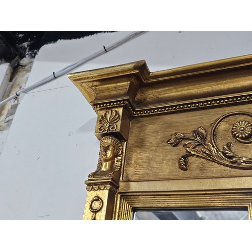 54 - A large ornate gilded triple over mantle bevel edged mirror with a Egyptian frieze to the top, a pha... 