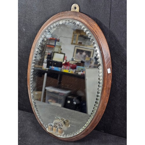59 - A good quality antique oval shaped bevel shaped mirror with fluting to the edge of the mirror, the m... 