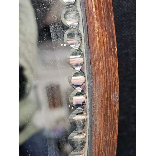 59 - A good quality antique oval shaped bevel shaped mirror with fluting to the edge of the mirror, the m... 