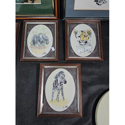 60 - A collection of 8x framed and glazed pictures to include 3x needlepoint pictures of a Lion, Tiger an... 