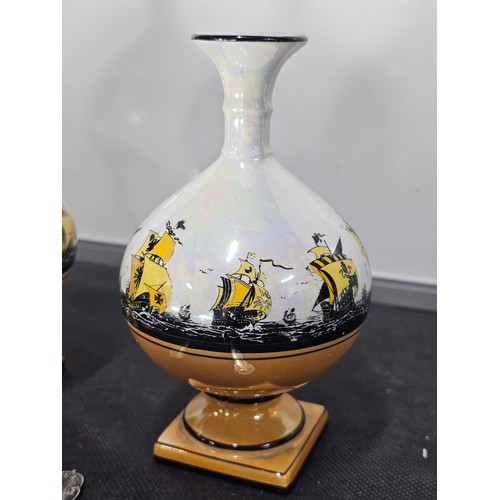 62 - Shelf full of collectables to include a very large trumpet vase in deep red along with 3x matching b... 