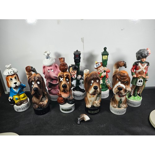64 - Collection of 9x vintage character decanters with musical bases to include a Scotsman on a lamp post... 