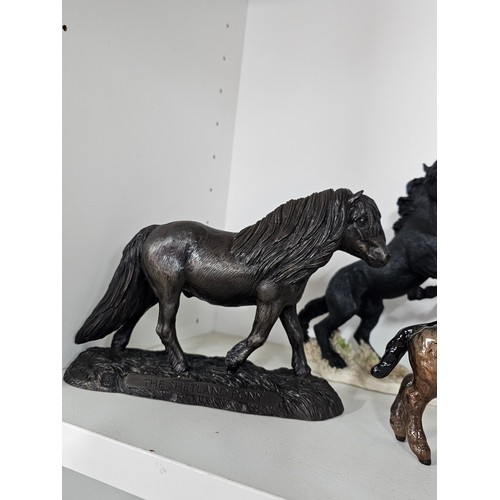 65 - A collection of ceramic horse figures to include a Beswick Sheltand pony and foal, the foal has chip... 